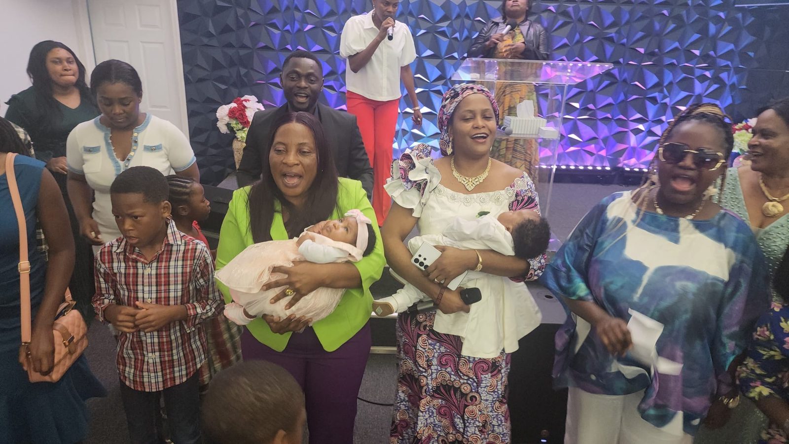 Parents holding their baby during a dedication