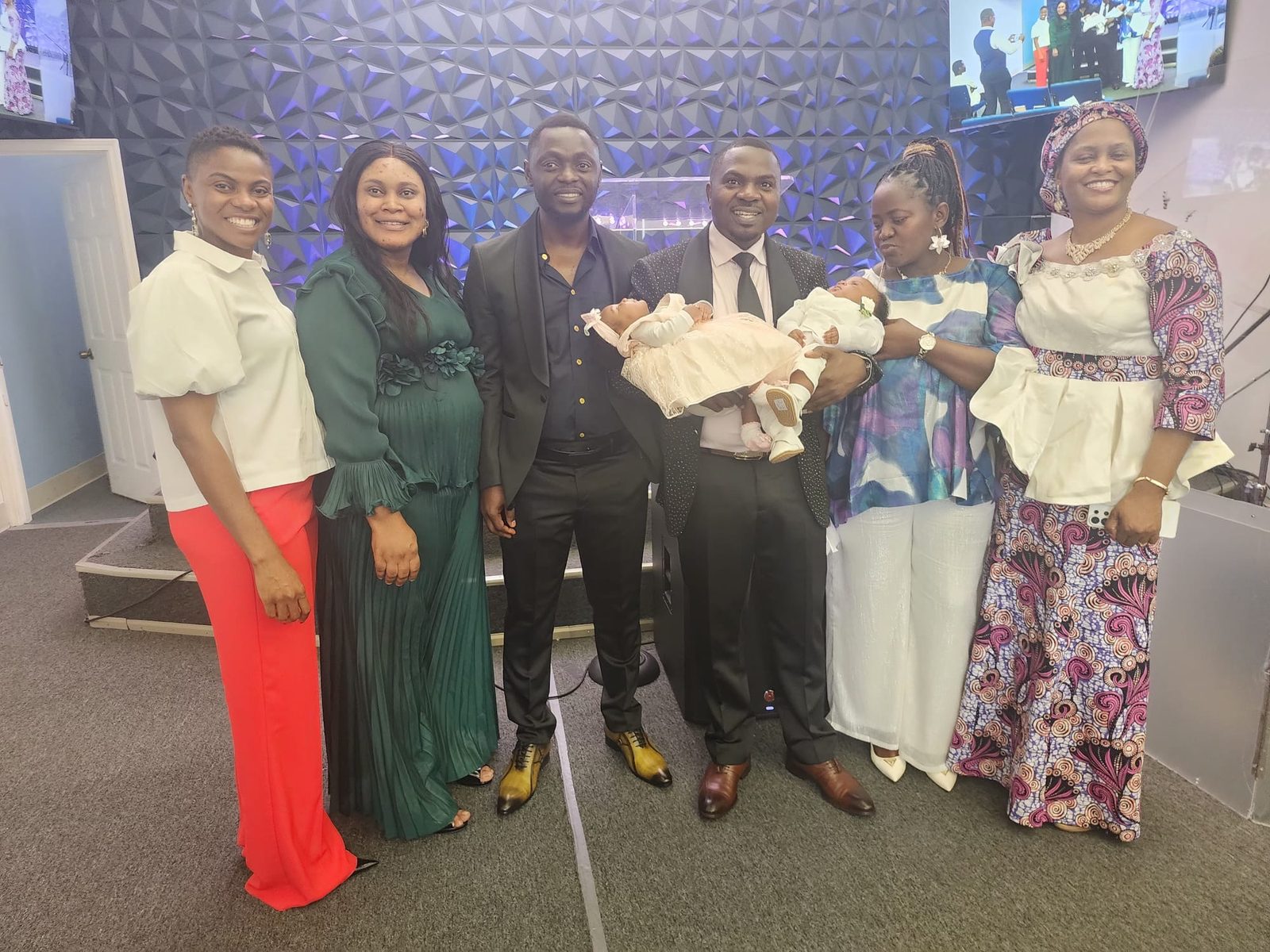 A family on stage for a baby dedication