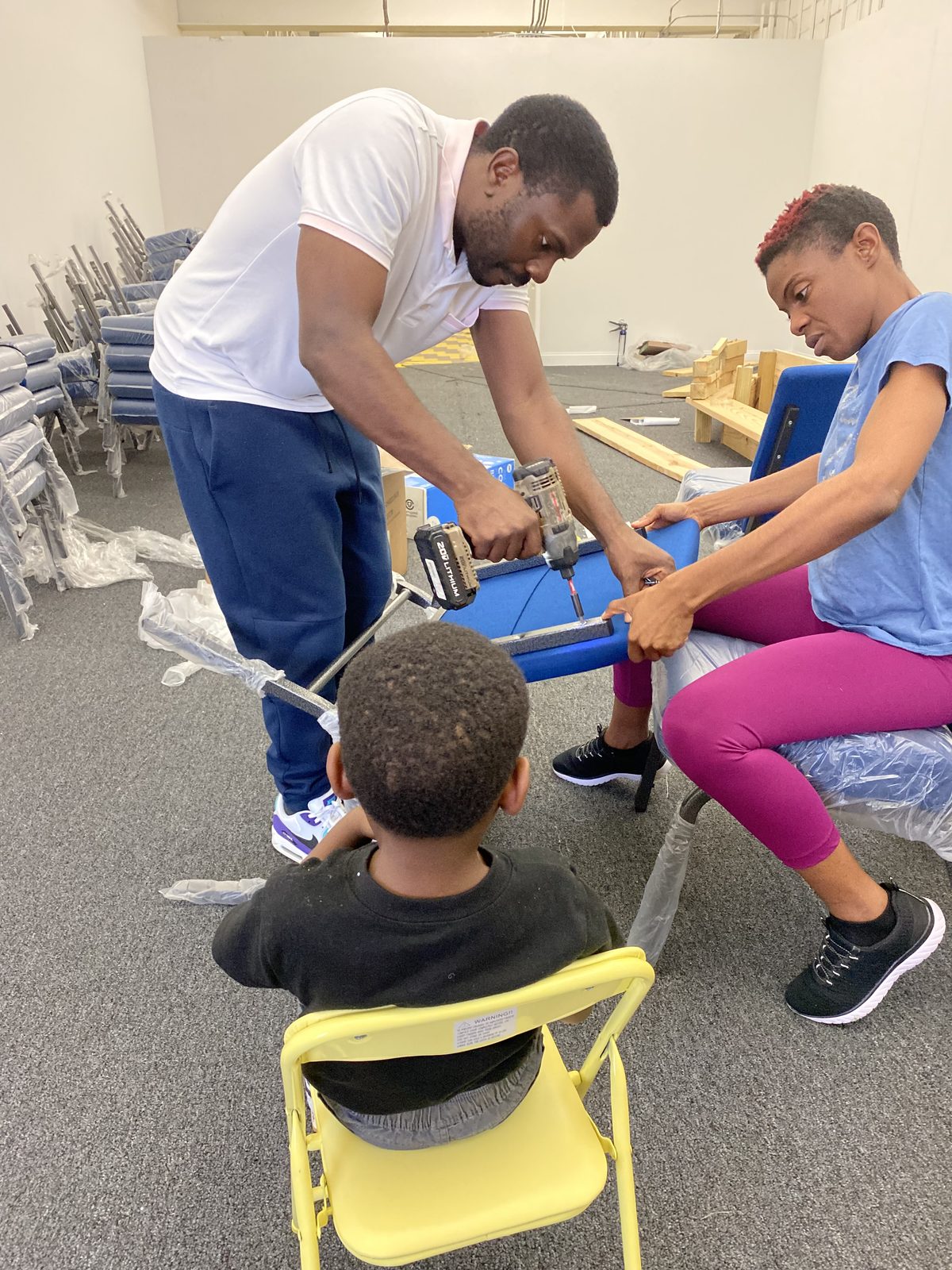 Two members assembling a sanctuary chair
