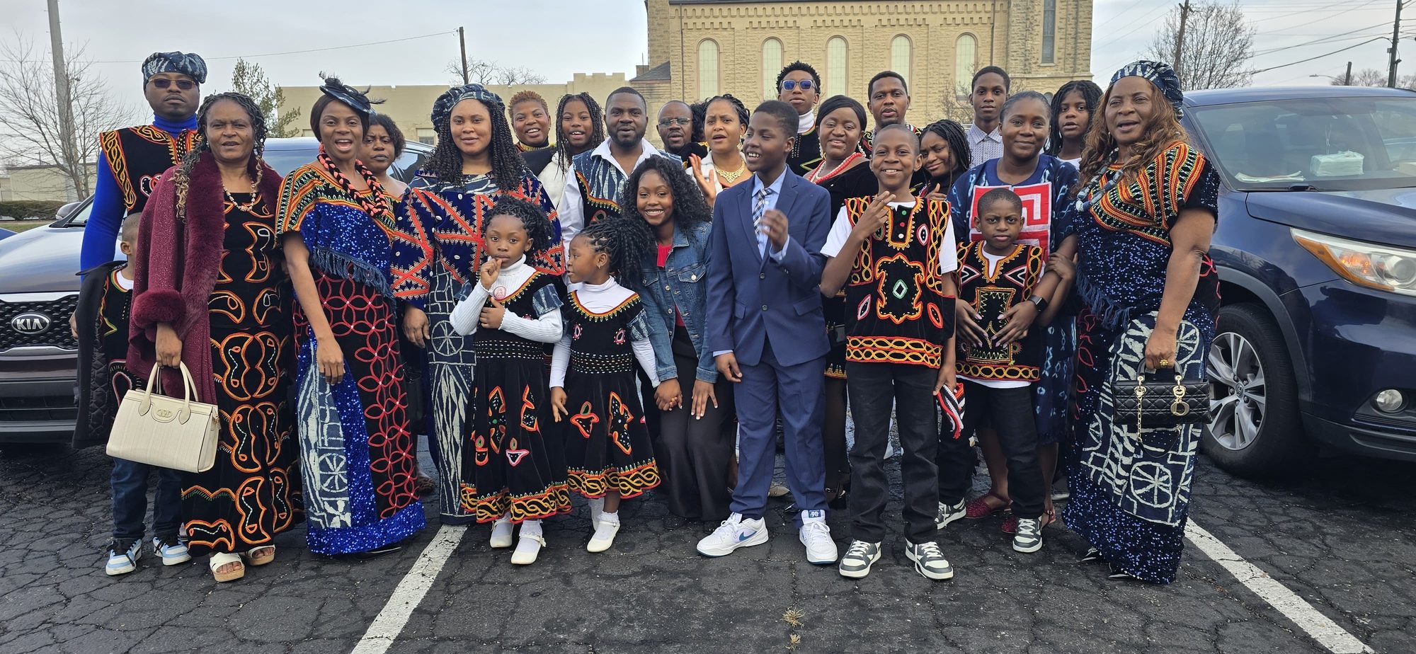 The congregation in traditional attire outside the church