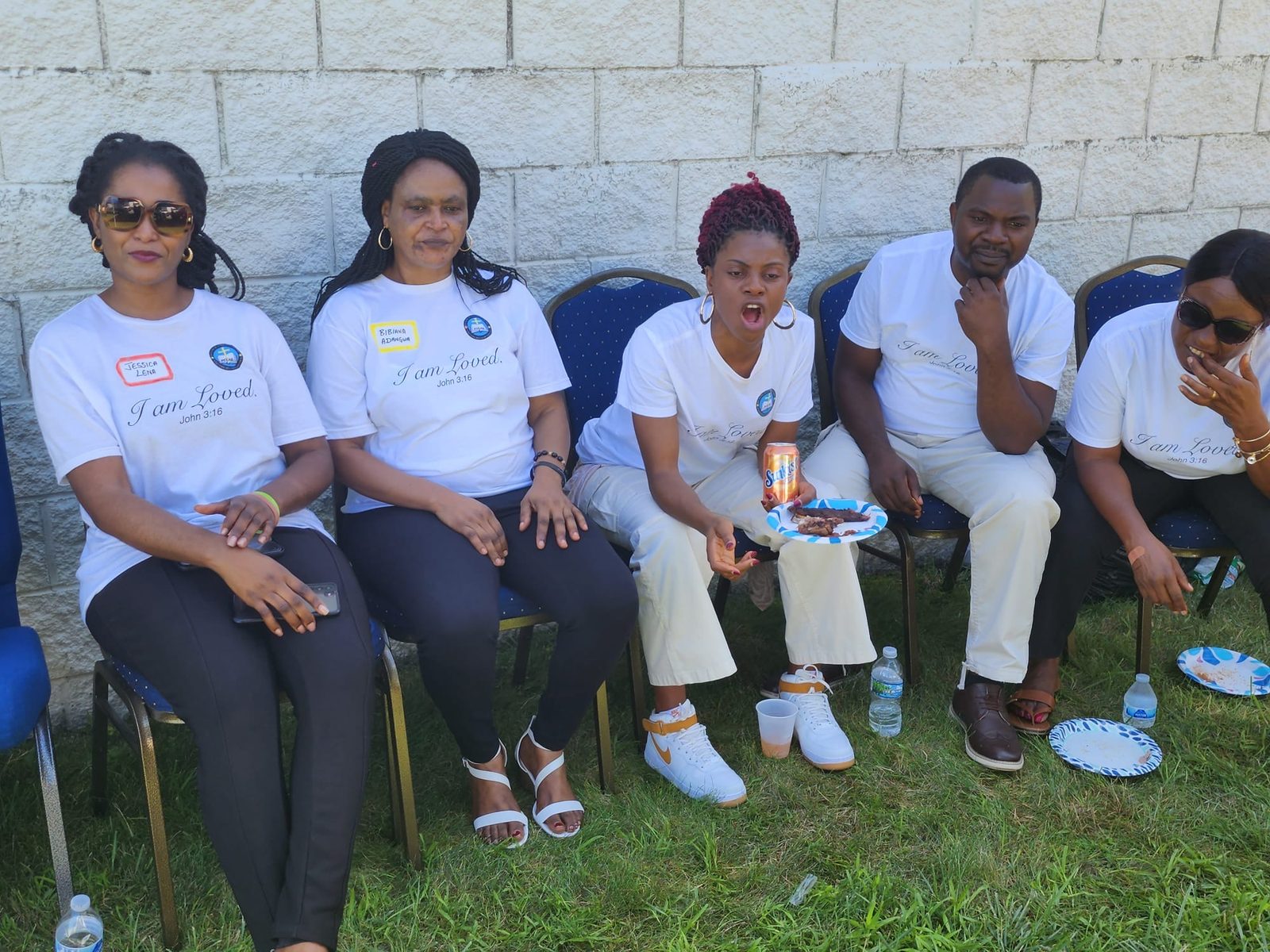 Members eating together outdoors after service