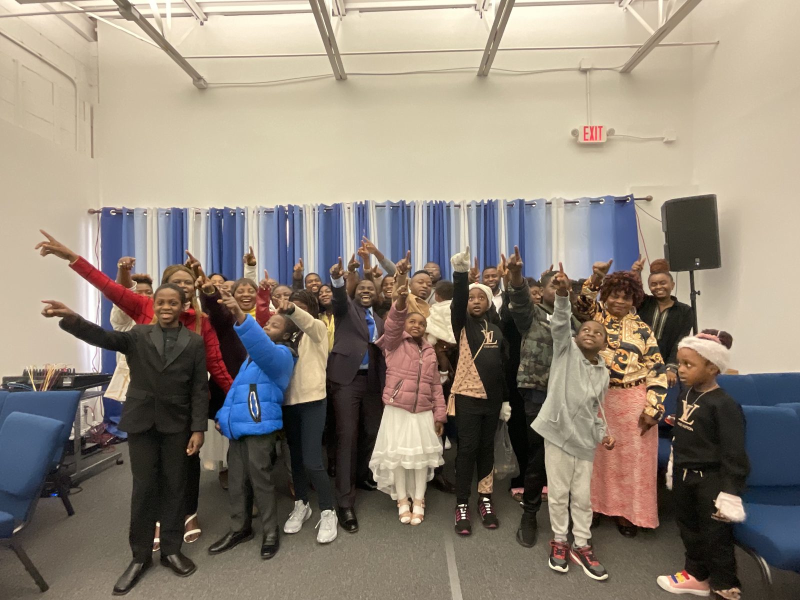Children with their hands raised in praise